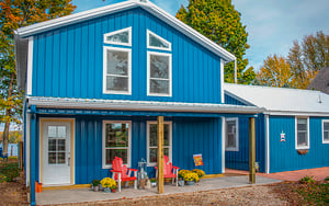 blue pole barn home on lake